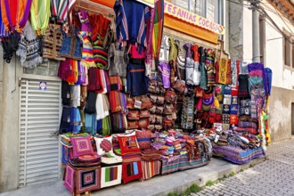 A market stall with colourful, handmade textiles and artistically designed fabrics at a lively