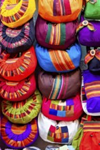 Close-up of colourful handmade bags with traditional patterns and vibrant colours, souvenir shops