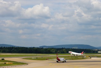 Swiss Airlines Passenger Airplane Take Off From the Runway and Flying Against Blue Sky and Clouds