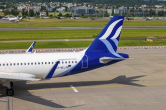 Aegean Airlines Passenger Airplane Taxiing on Runway in a Sunny Summer Day From the Airport in