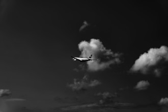 Swiss Airlines Passenger Airplane Flying Against Sky and Clouds in a Sunny Summer Day From the