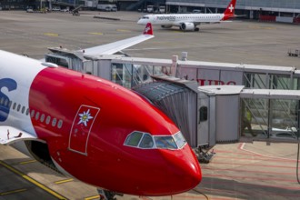 Zurich Airport and Passenger Airplane and Boarding Bridge Gate on Airfield in a Sunny Summer Day
