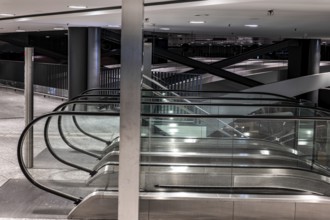 Inside Illuminated Zurich Airport with Escalator at Night in the Airport in Kloten, Zurich, Zurich