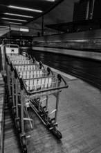 Many Luggage Trolley on Railroad Station in Circle in Zurich Airport at Dusk in Kloten, Zurich,