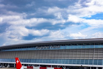 Zurich Airport and Building on Airfield in a Sunny Summer Day with Blue Sky and Clouds From the