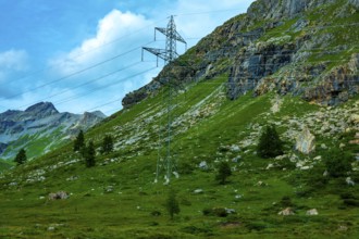 Electricity Pylon with Mountain View in the Swiss Alps in a Sunny Summer Day in Bernina,