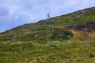 Electricity Pylon with Mountain View in the Swiss Alps in a Sunny Summer Day in Bernina,