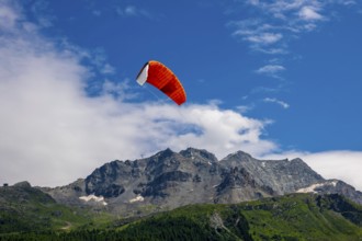 Kitesail and Mountain Peak in the Swiss Alps on Alpine Lake Silvaplana in a Sunny Summer Day in