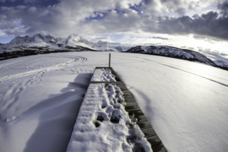 Norway tromsö snow mountains lake jetty frozen