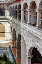 Historic courtyard with classic stone arches and modern glass design, San Fransisco Cathedral in La