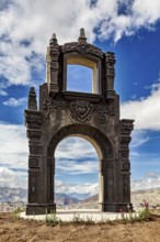 An imposing stone gate with fine details under a dramatic cloudy sky, The gate at the Killi Killi
