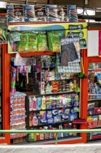 Variety of household products in a well-stocked, colourful supermarket, small shops and restaurants