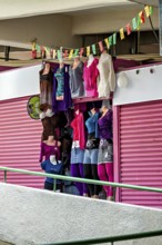 Shop window with colourful, modern clothing in a feminine shop, Small shops and restaurants in the