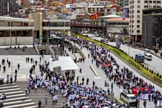 Crowds gather on stairs and streets, next to urban buildings with traffic, A demonstration in the