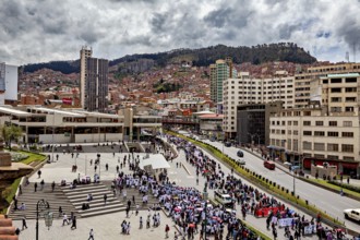 Bustling city atmosphere with people gathering in a large square surrounded by urban architecture