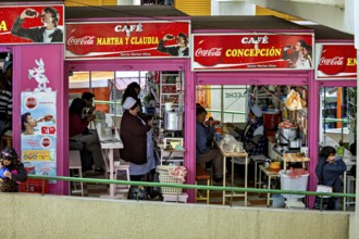 Friendly café with people eating, eye-catching Coca-Cola advert, Small shops and restaurants in the