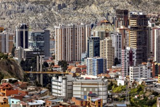 Modern high-rise buildings in an urban environment against a mountain backdrop, The houses and