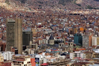 Urban landscape with cathedral in front of mountains and dense houses, The houses and skyscrapers