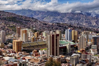 Panorama of La Paz with a view of skyscrapers and a stadium against a mountain backdrop, The houses