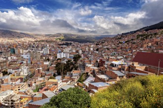 Hilly cityscape of La Paz with red roofs and cloudy skies, The houses and skyscrapers of the city