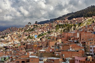 Houses spread across the hilly landscape of La Paz under a cloudy sky, The houses and skyscrapers