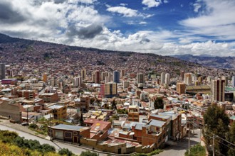 Sweeping city view with hilly landscape and clouds, The houses and skyscrapers of the city centre