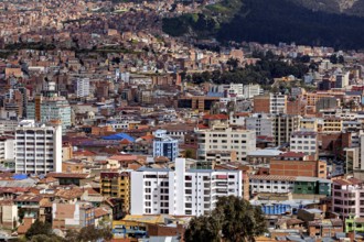 Urban panorama with surrounding mountains and numerous buildings, The houses and skyscrapers of the