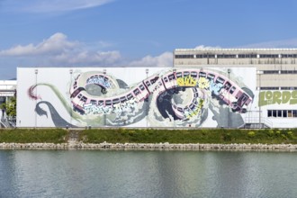Large-scale dynamic graffiti depiction of a winding train, at the harbour in Linz, Upper Austria