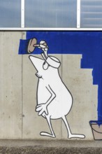 Cartoon painter painting an abstract blue surface on a concrete wall at the harbour of Linz Upper