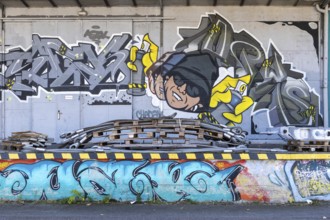 Humorous graffiti with a man and colourful lettering, at the port of Linz Upper Austria Austria
