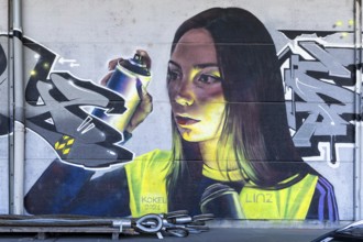 Realistic portrait of a woman with spray cans in her hand, at the harbour Linz Upper Austria