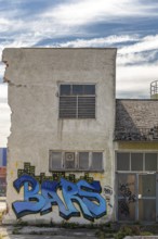 Graffiti with the word Bars on a dilapidated, urban building, at the harbour Linz Upper Austria