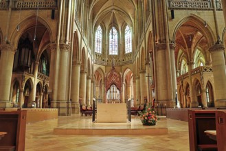 Magnificent interior of a Gothic church with high vaults and colourful stained glass windows, Maria