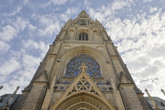 Detailed Gothic church façade rises dramatically into the cloudy sky, Maria Empfängnis Dom Linz