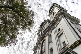 Impressive view of a baroque church from below with silhouette of trees, Pöstlingsbergkirche