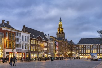 Shops at the fish market Vismarkt and the church tower Martinitoren or Martinitower of the