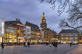 Shops at the fish market Vismarkt and the church tower Martinitoren or Martinitower of the