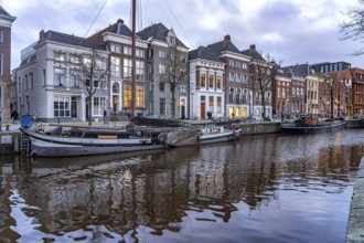 Typical canal with sailing boats in Groningen at dusk, Netherlands