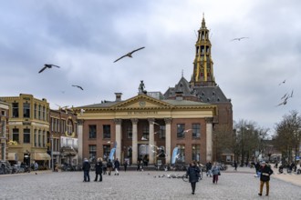 The Vismarkt fish market with the Korenbeurs former grain exchange and the steeple of the Aa church