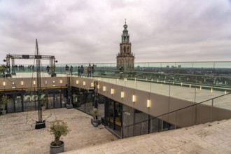 Roof terrace of the Forum Groningen and the Martinitoren church tower of the Martinikerk or Martini