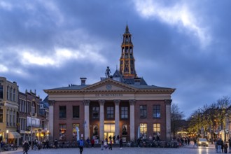 The Vismarkt fish market with the Korenbeurs former grain exchange and the steeple of the Aa church