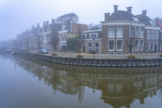 Typical canal in the winter fog, Harlingen, Friesland, Netherlands