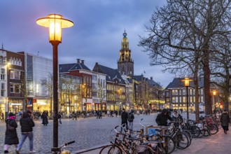 Shops at the fish market Vismarkt and the church tower Martinitoren or Martinitower of the