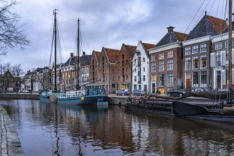 Typical canal with sailing boats in Groningen at dusk, Netherlands