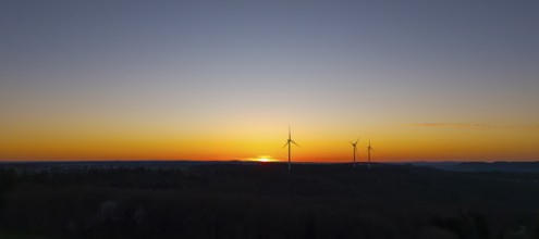 Silhouette of wind turbines at sunset in the distance, near Schorndorf im Remstal,