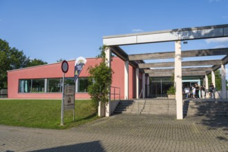 Teenagers in front of the entrance to the indoor swimming pool, Aqua Riese, Bad Staffelstein, Upper
