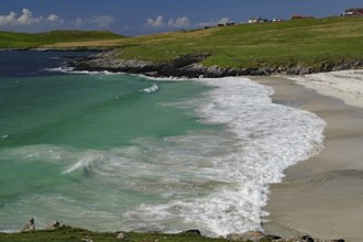 A picturesque beach with turquoise water and gentle waves under a blue sky, Scalloway, Shetland