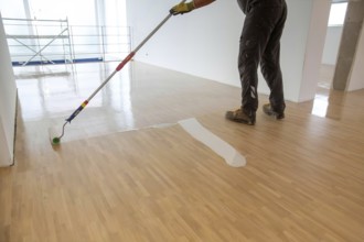 Professional sealing of a new parquet floor with lacquer