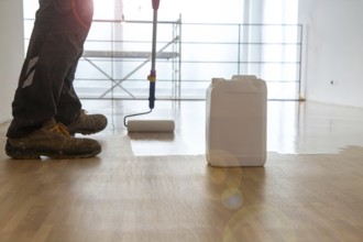 Professional sealing of a new parquet floor with lacquer