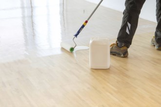 Professional sealing of a new parquet floor with lacquer